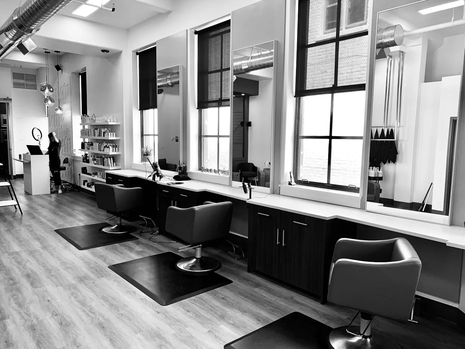 Illustrative black and white salon interior with mirrors and styling chairs