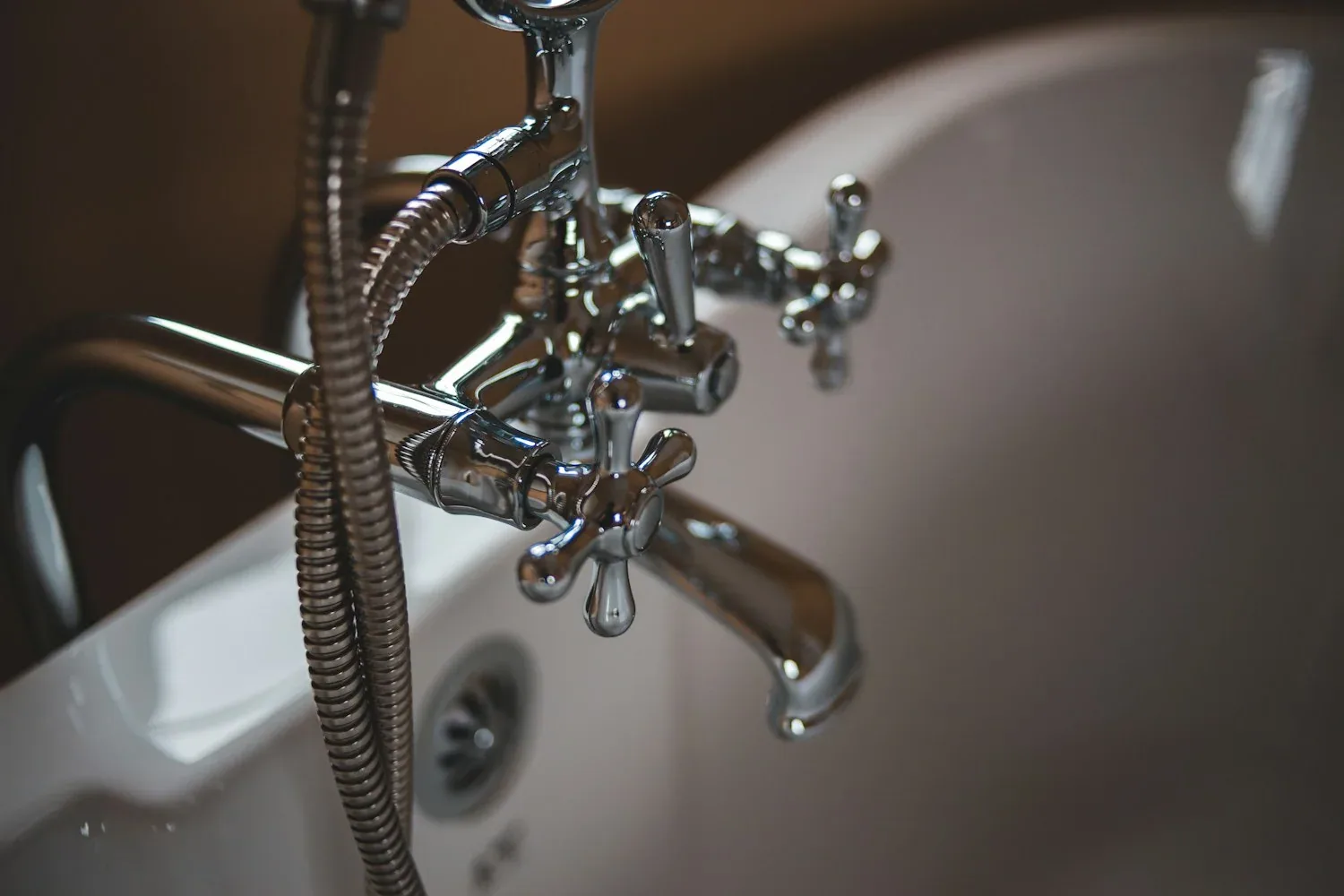 Illustrative chrome bath taps and shower fitting